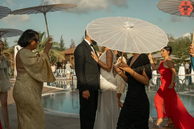 bride groom parasol poolside kiss wedding ceremony — GOGA Photography